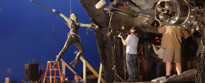 Drax holds baby doll head in behind the scenes guardians 2 pic
