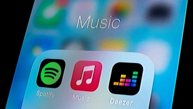 In this photo illustration, a Spotify app, Apple Music app and Deezer app are seen displayed on a smartphone.