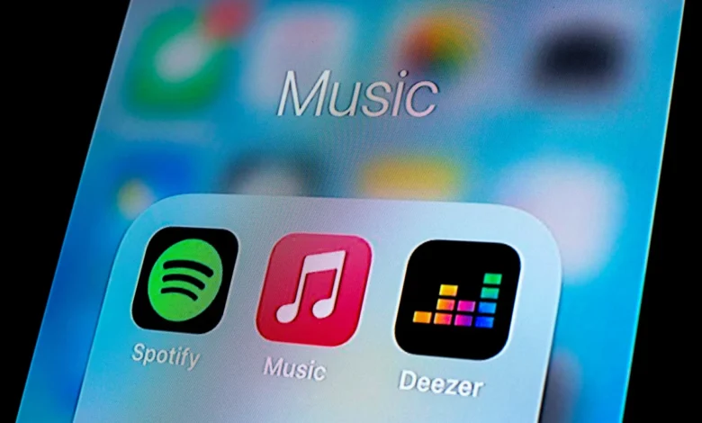 In this photo illustration, a Spotify app, Apple Music app and Deezer app are seen displayed on a smartphone.